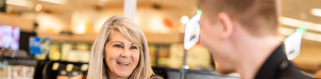 Retail clerk Associate helping customer at checkout